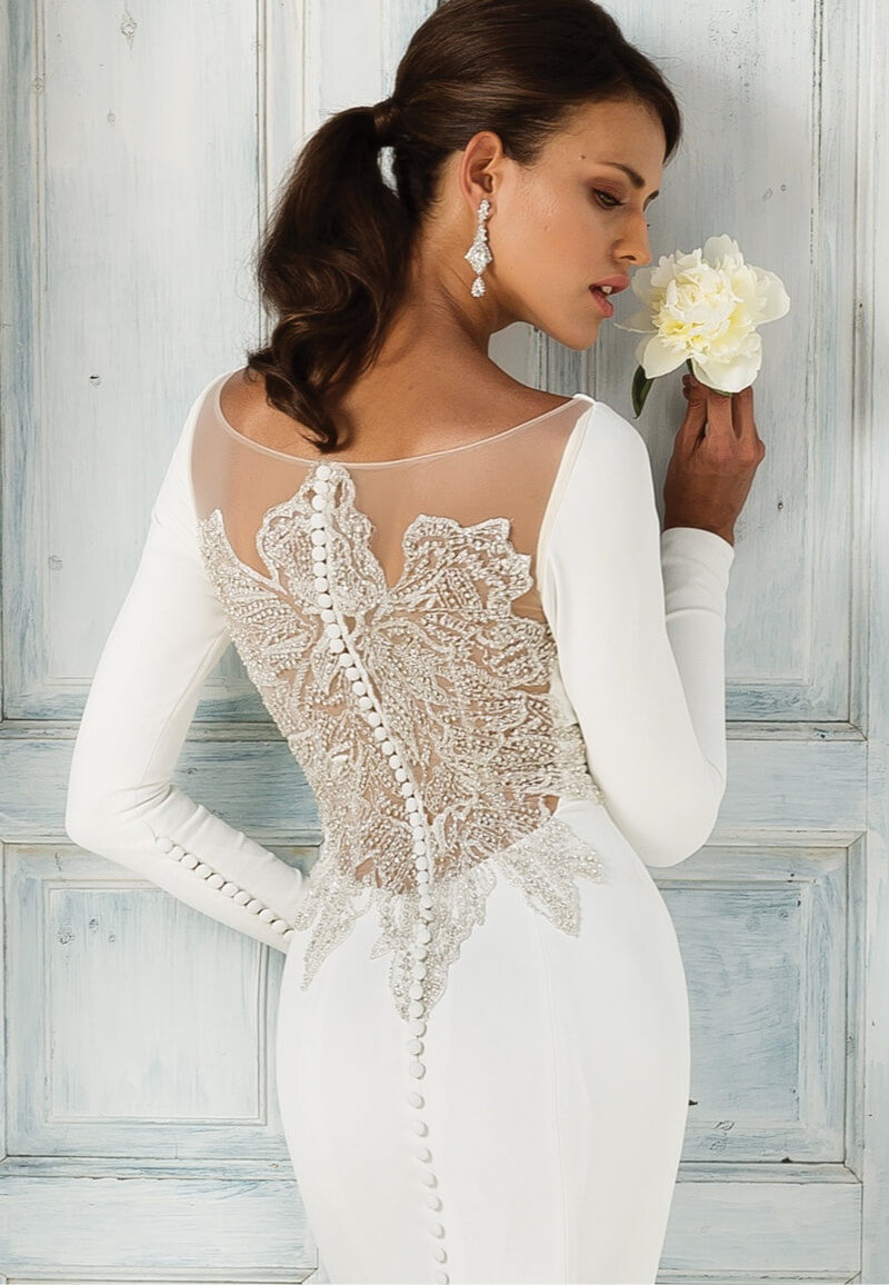 Model wearing white Justin Alexander dress