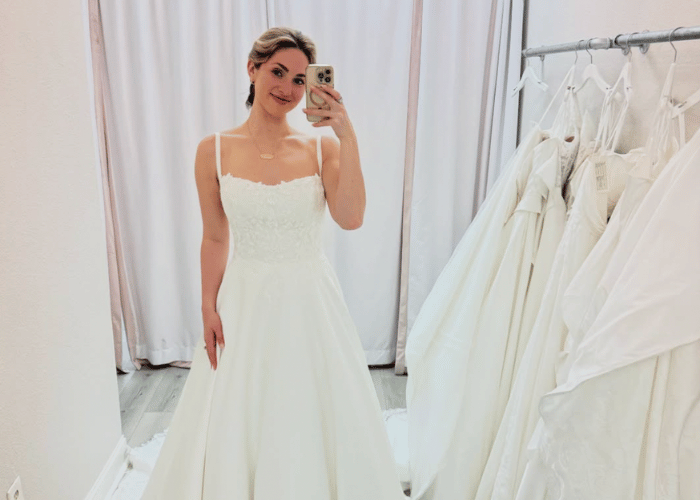 Bride in minimalist spaghetti strap wedding dress during fitting