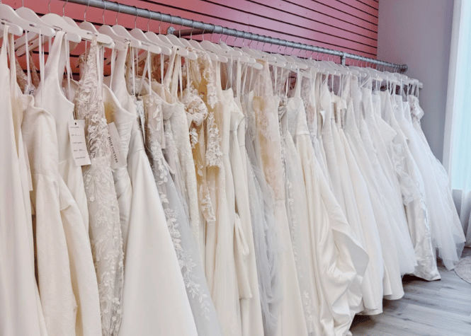 Wedding gown collection inside bridal boutique showroom