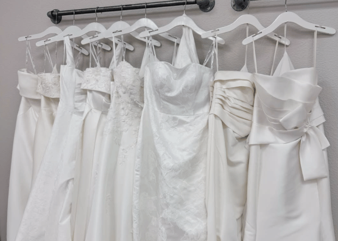 Wedding dresses hanging in bridal shop showroom