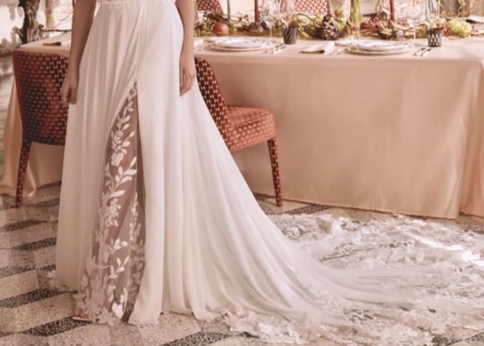 Sheer wedding dress with floral appliqu&eacute; and flowing cathedral train