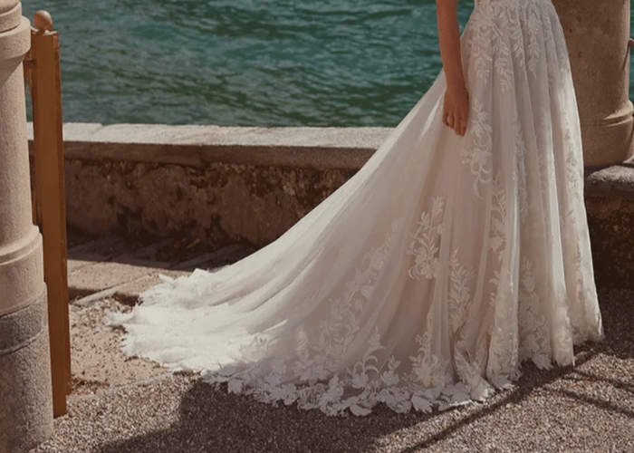 A-line lace wedding dress with long train by the water