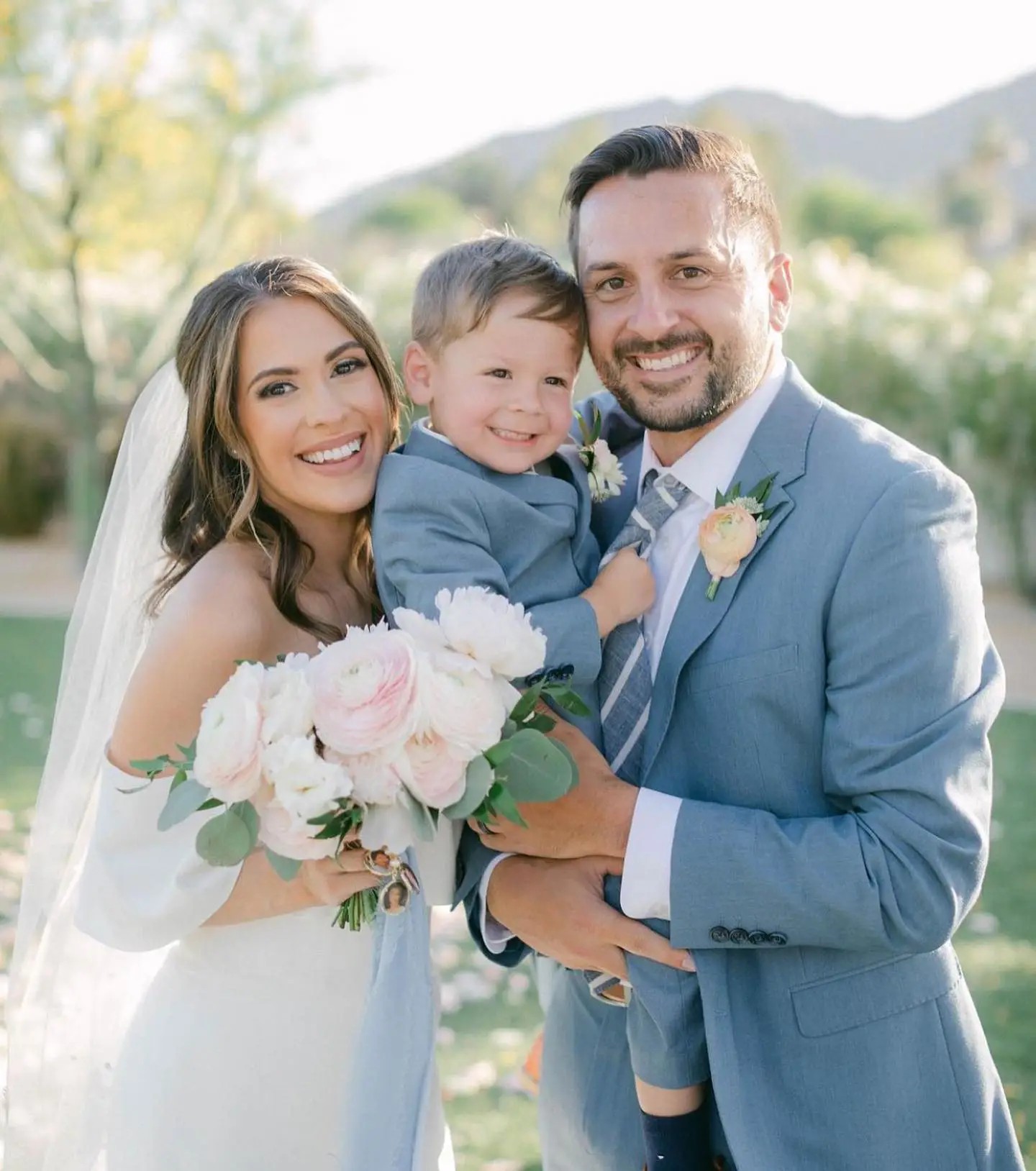 Olivier Couture Real Bride wearing a Lilian West Gown, with groom and kid