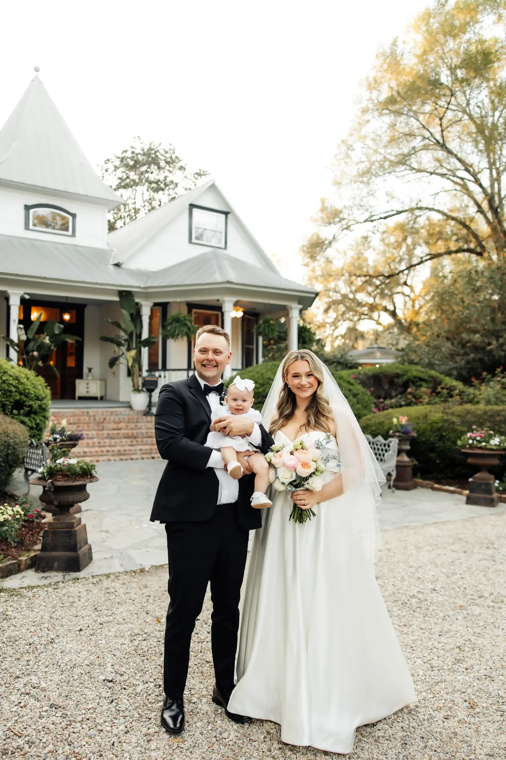 Real Bride and Groom holding a baby image
