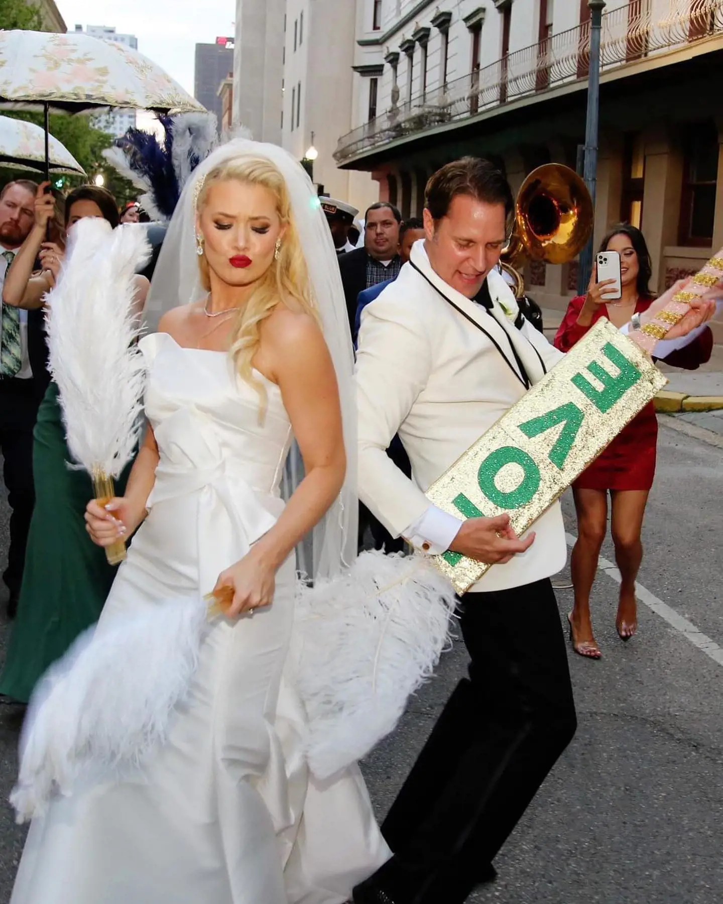 Photo of the real bride and groom holding "Love" guitar